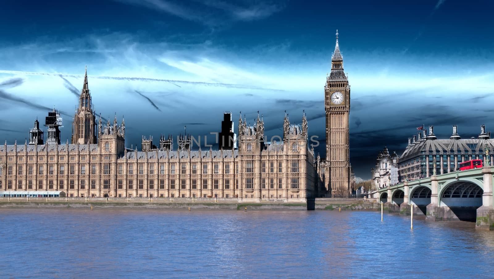 London, the UK. Red bus in motion and Big Ben, the Palace of Westminster. The icons of England in vintage, retro style