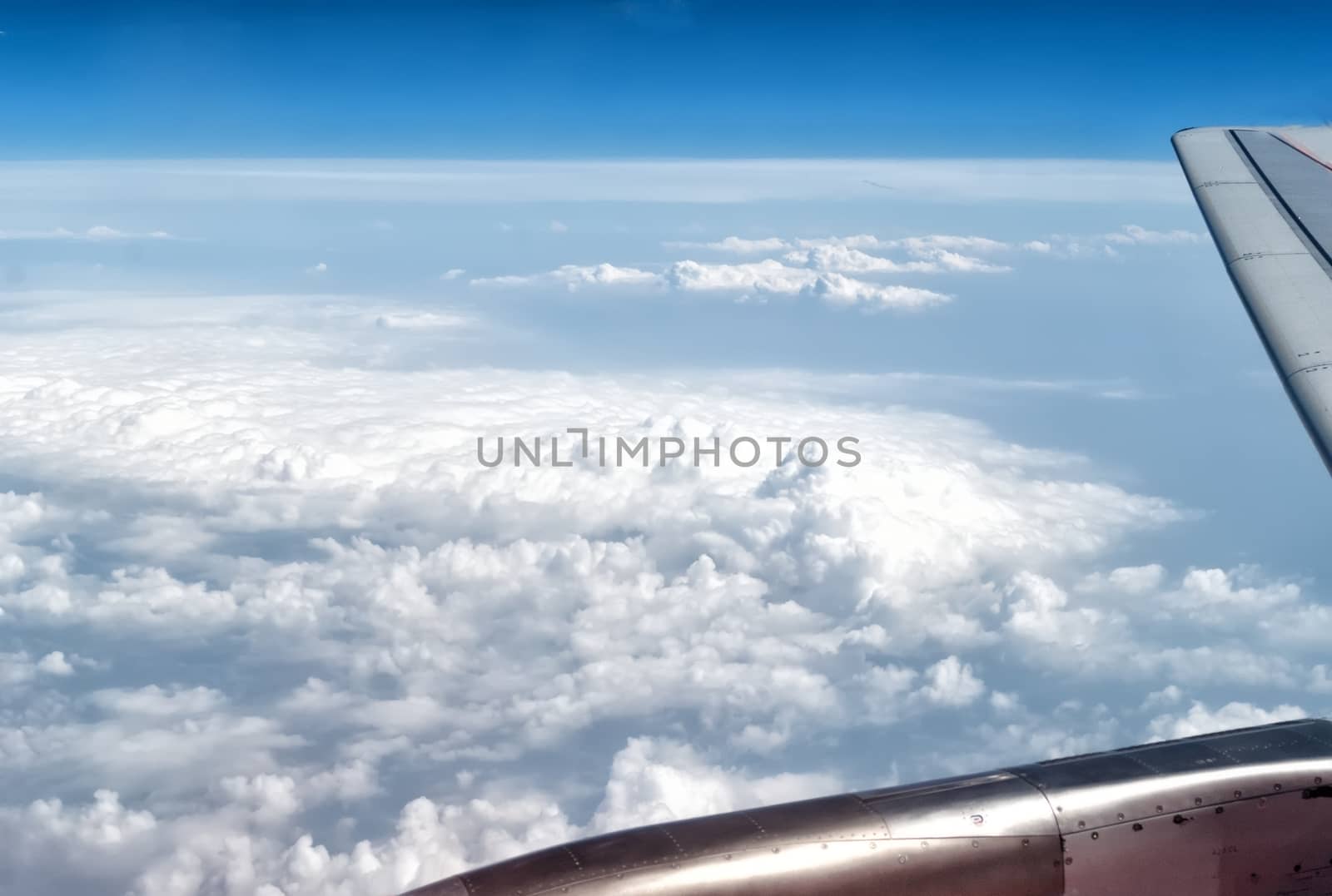 airplane wings in the blue clouds by mitakag