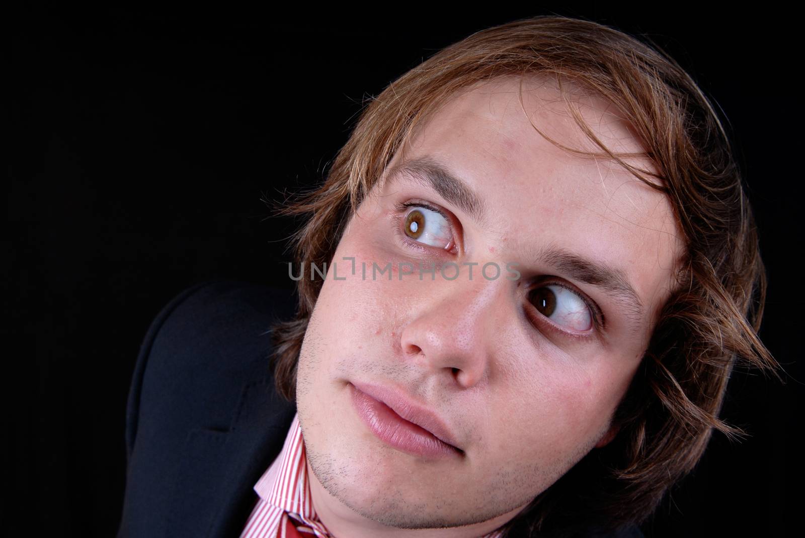 crazy young man portrait isolated on black