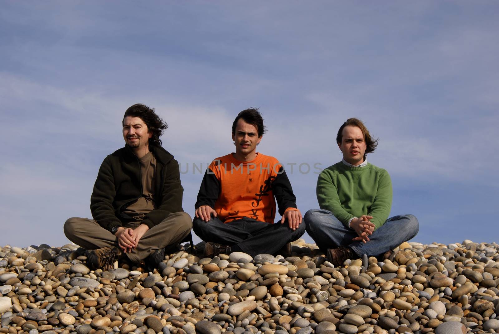 three casual young men at the beach