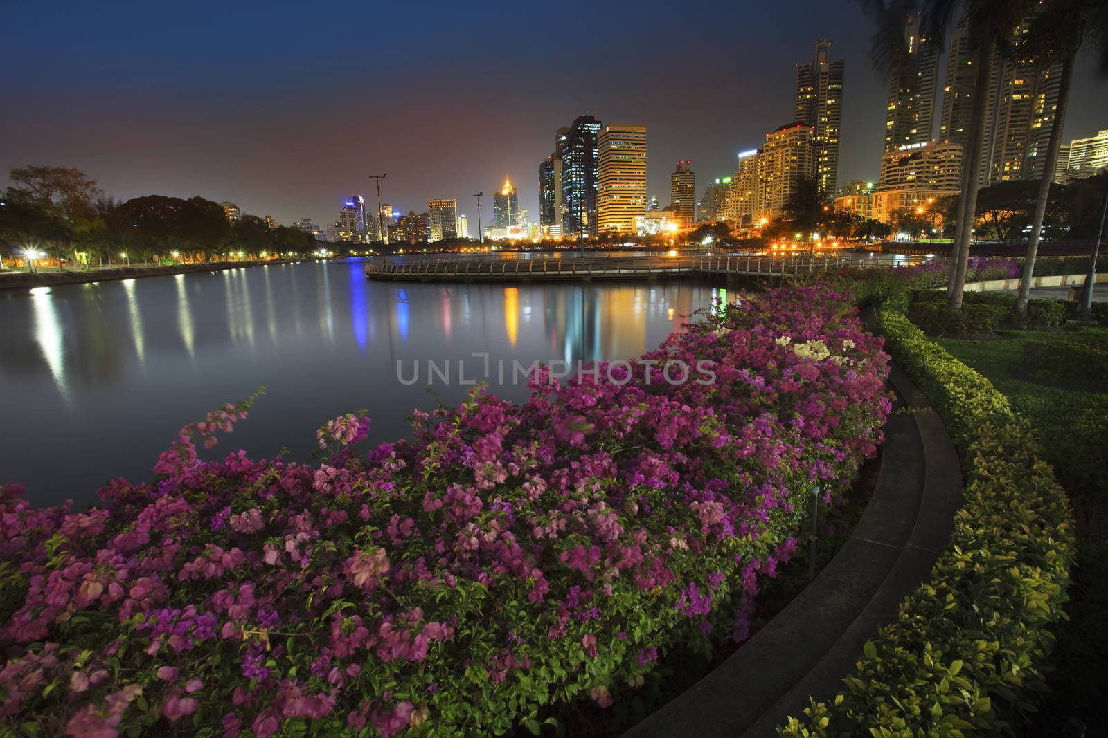 landscape of beautiful water pool important landmark of city life in Bangkok capital of thailand view point from  Benchakitti Park on dusky time 