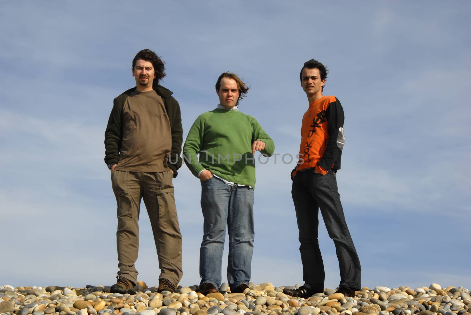 three casual young men at the beach