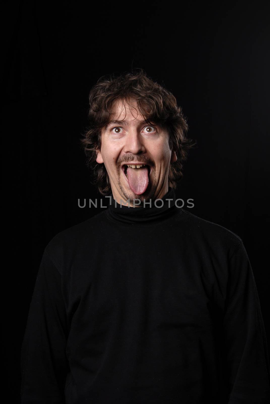 crazy young man portrait isolated on black