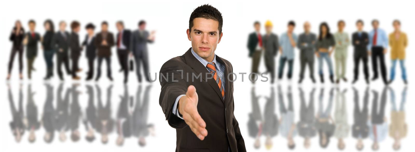 young business man offering his hand in front of a group of people