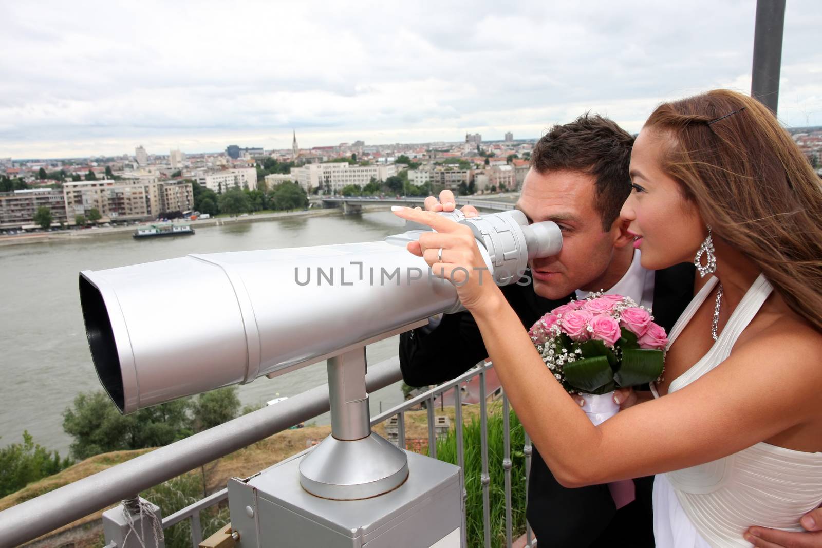 Wedding on the nature, young wedding couple with tourist binoculars