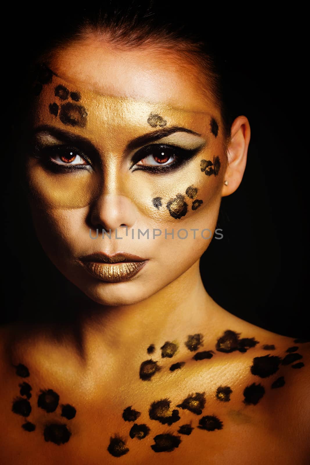 Attractive young girl with makeup wild leopard close-up portrait