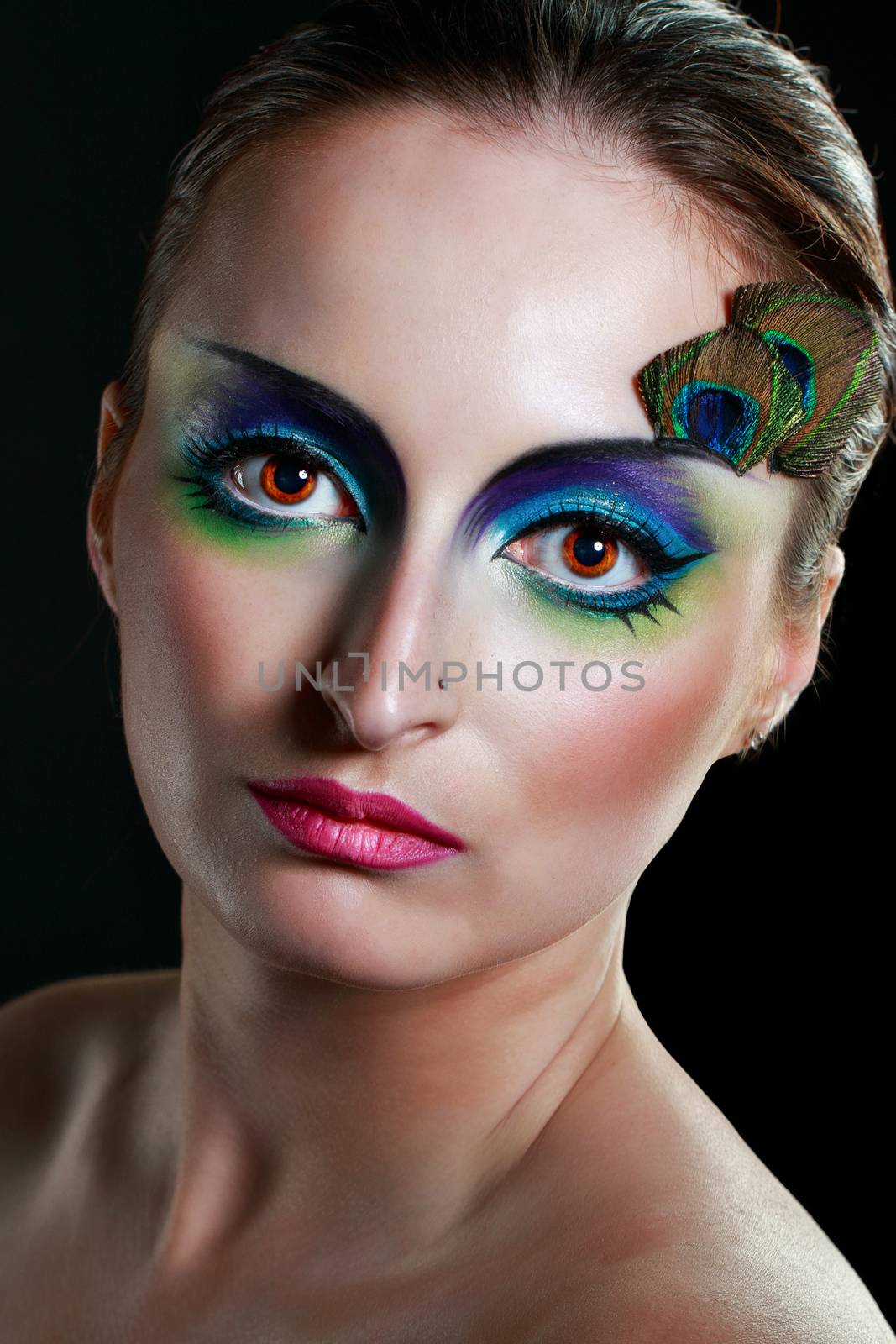 Attractive young girl with makeup peacock bird closeup portrait