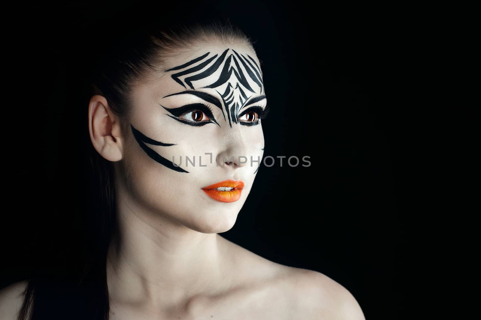 Attractive young girl with make-up of wild zebra close-up portrait