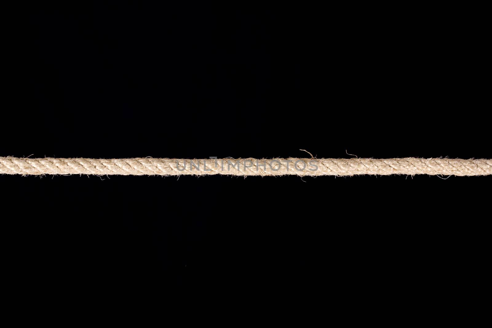 Twisted manila rope isolated on black background