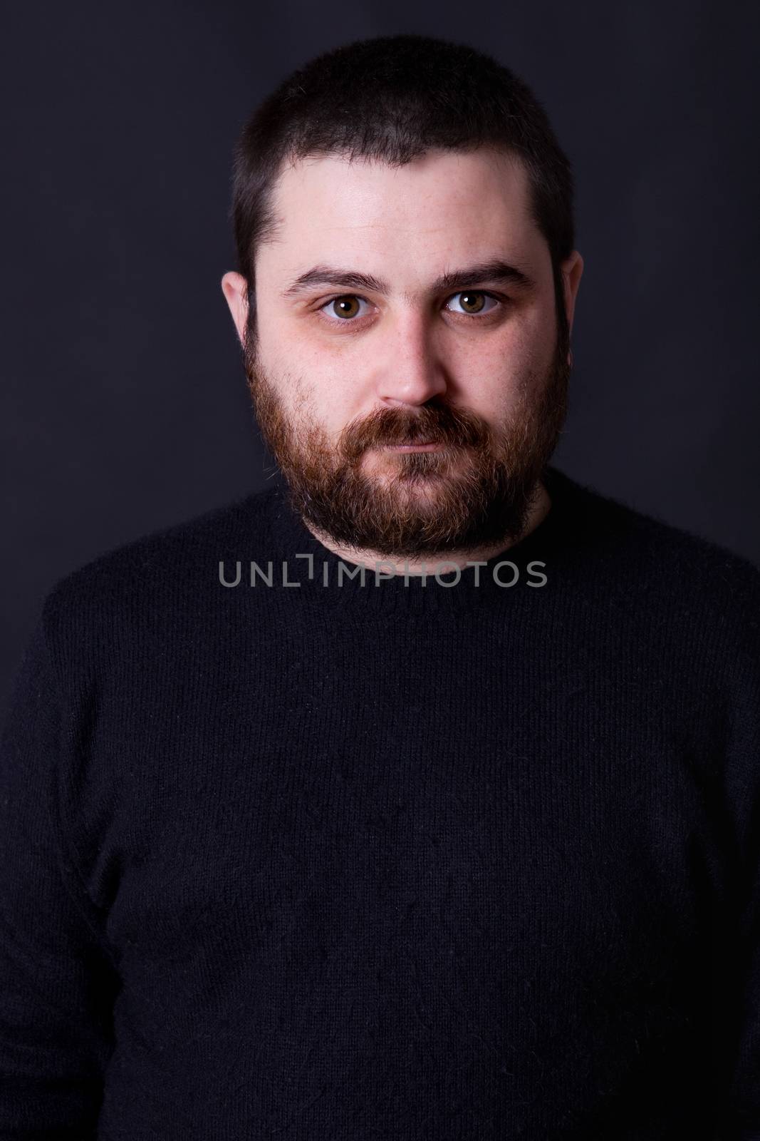 young casual man portrait on a black background