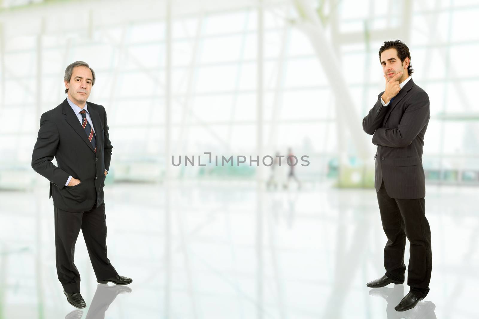 two business men standing at the office