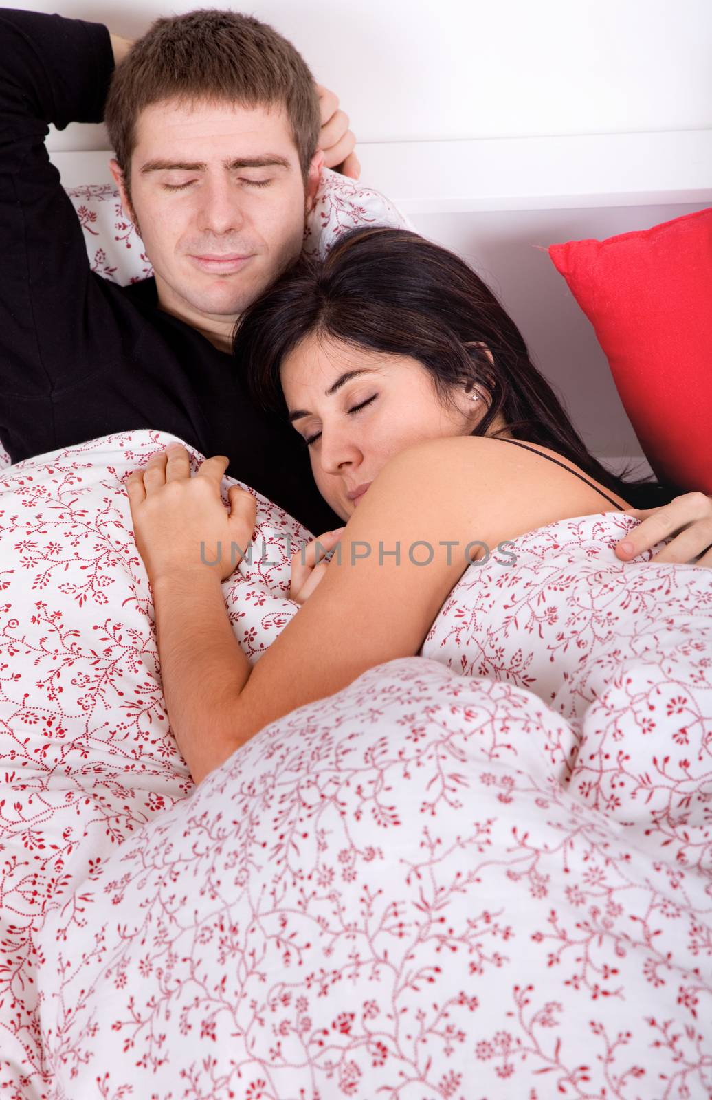 an young couple in bed, studio picture