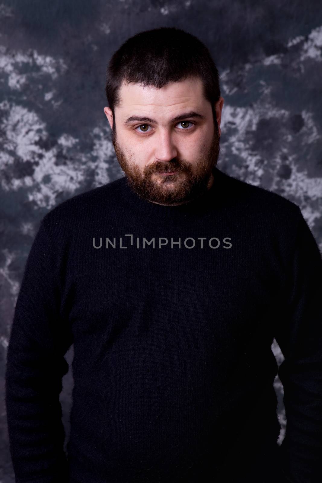 young casual man portrait on a dark background