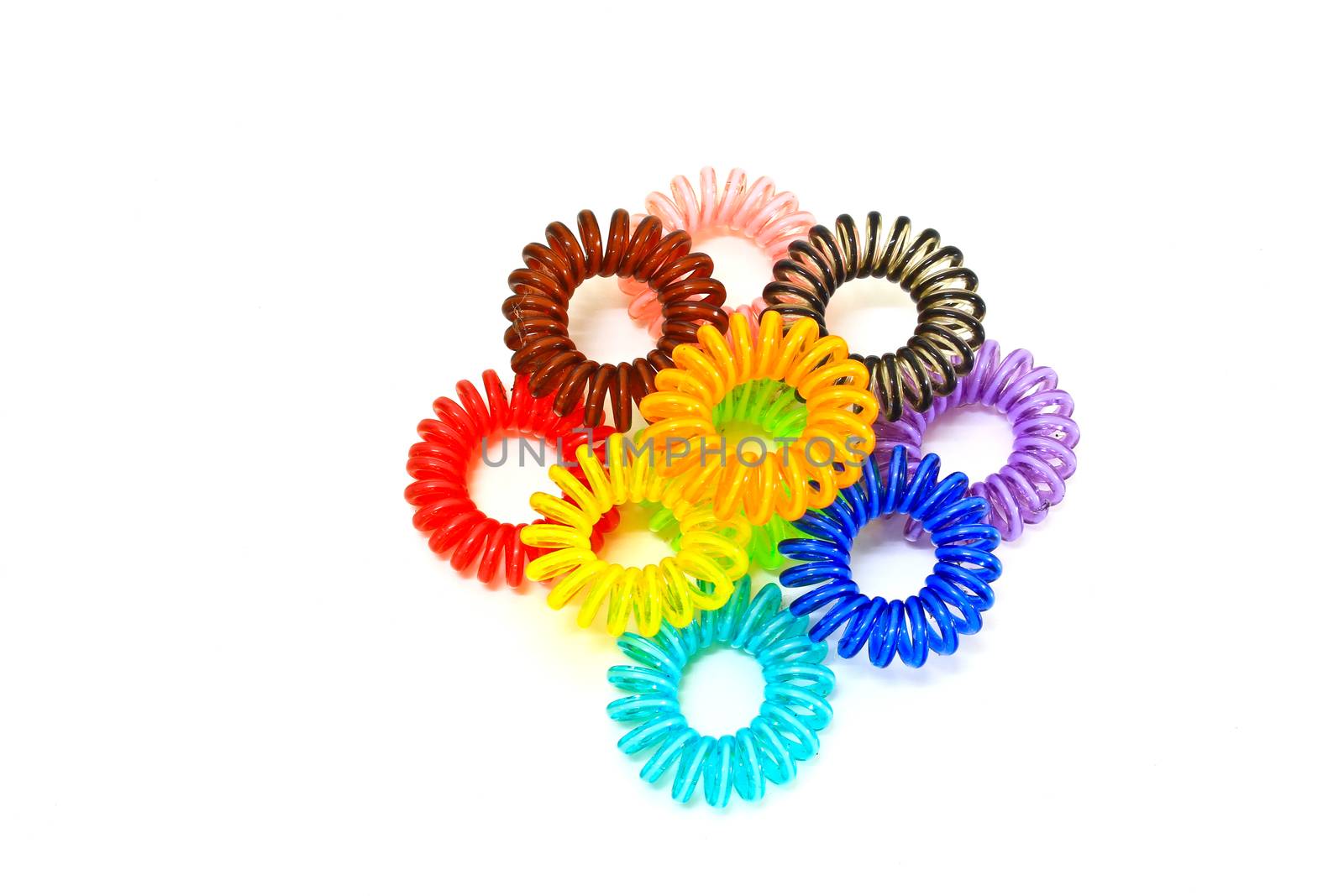Spiral colorful elastic hair ties used on a white background.