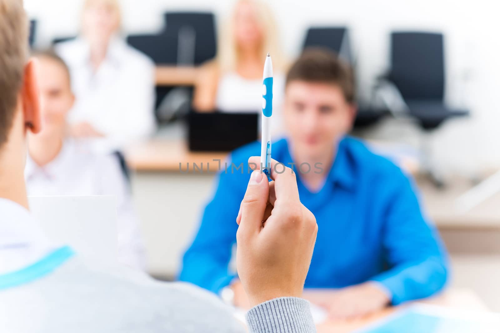 close-up of hands of a teacher with a ballpoint pen, the teacher focuses attention on himself gesture