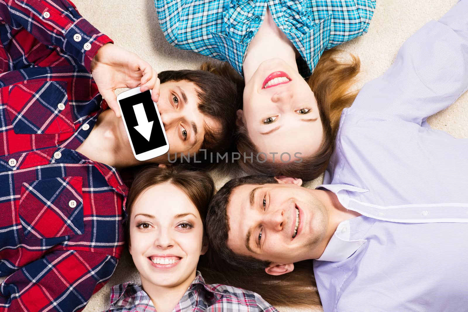 four young people are together, the young man pressed his lips to the phone