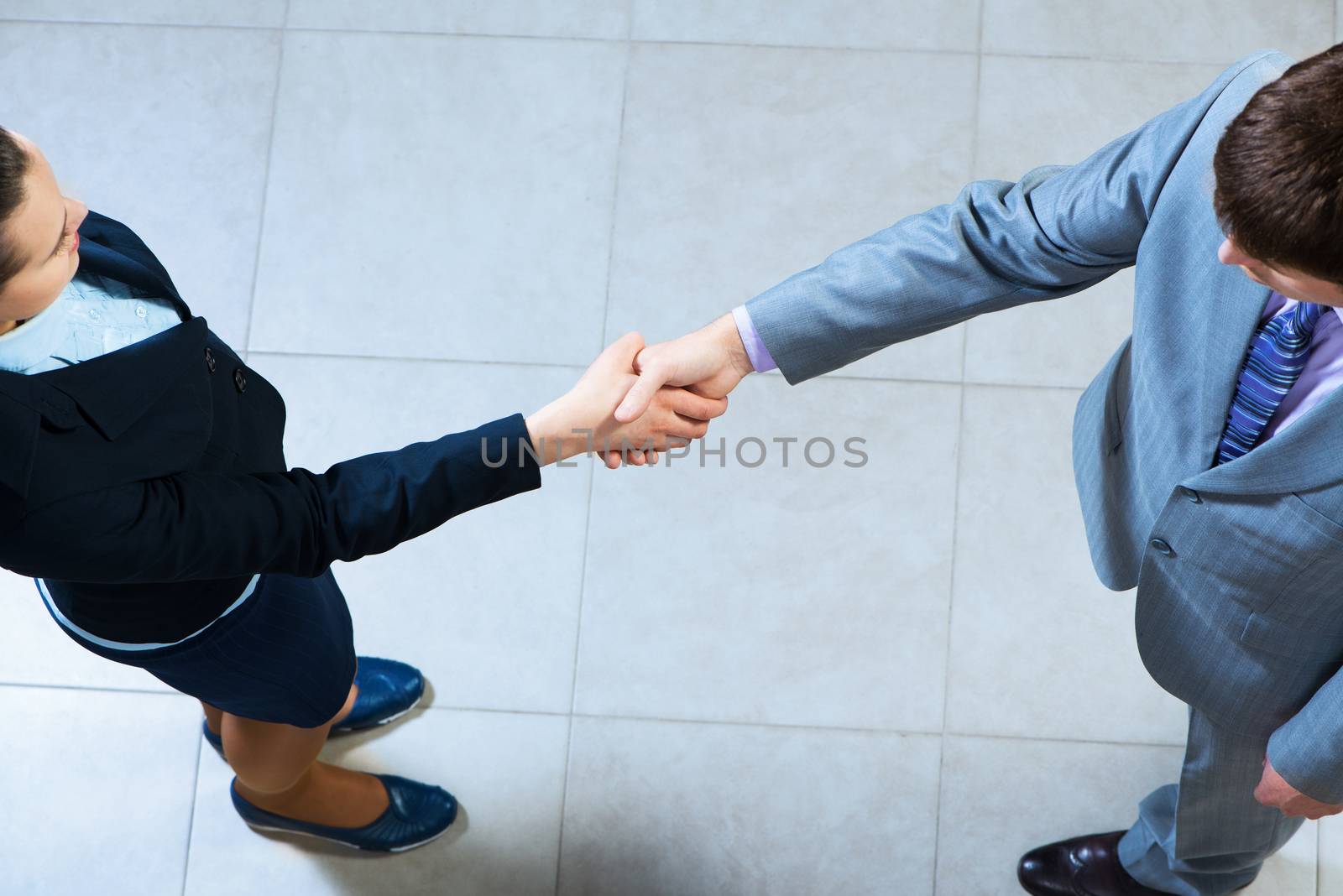 Business woman and businessman shaking hands, reach agreement