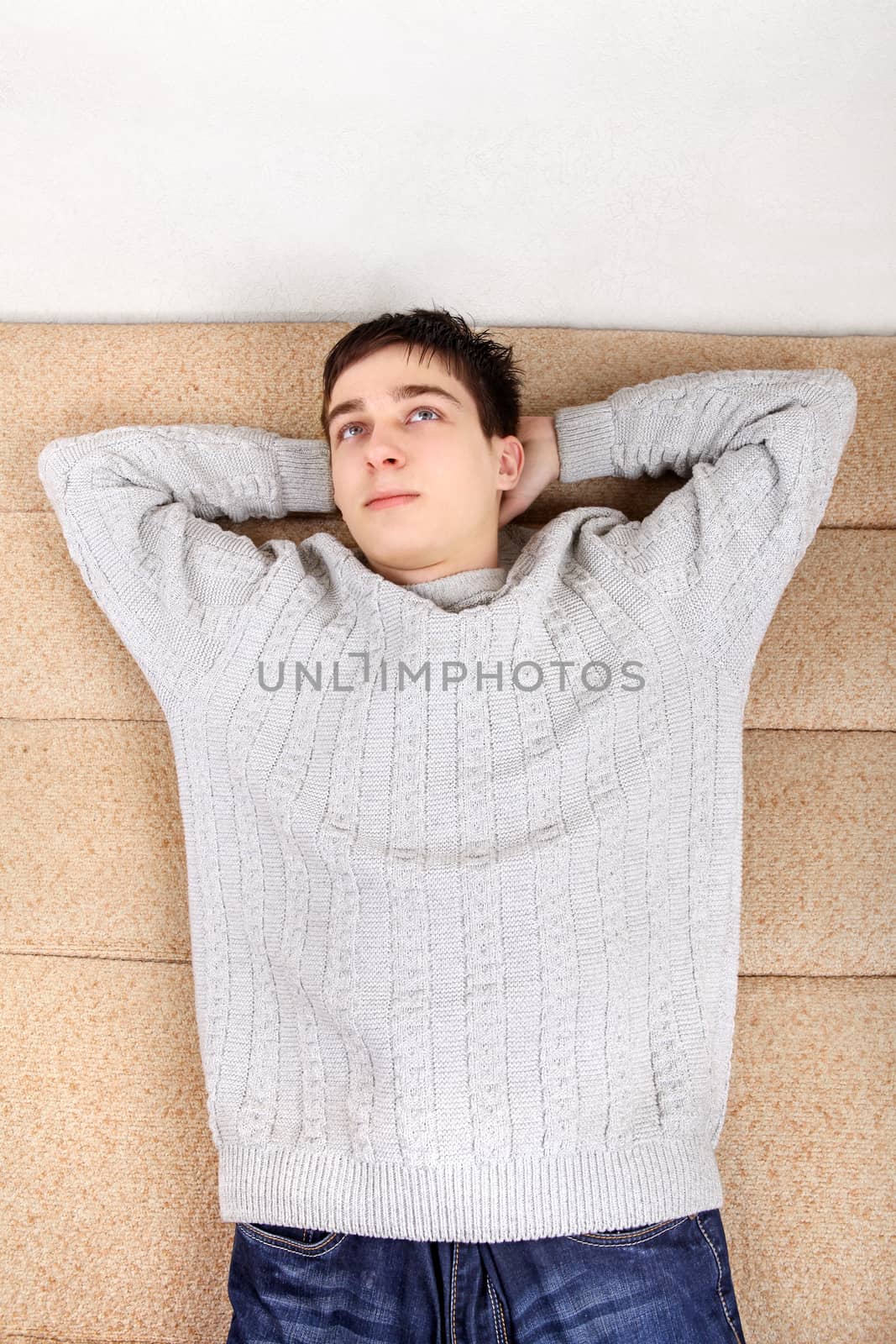 Teenager resting on Sofa at the Home