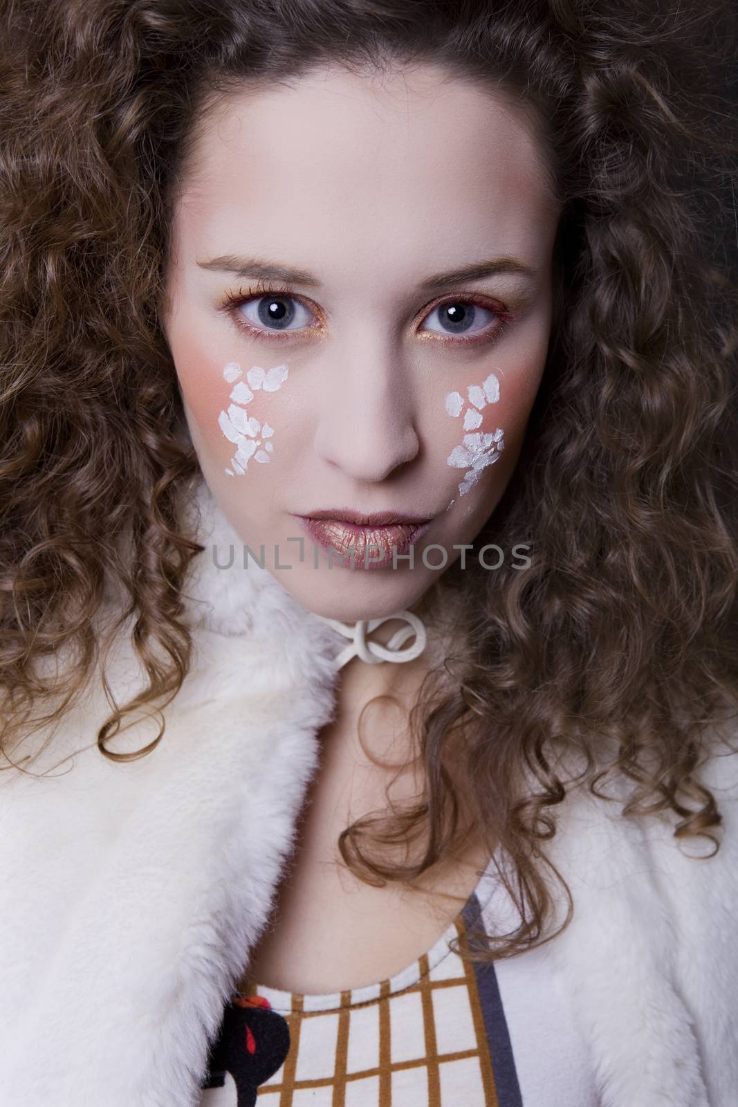 young beautiful woman close up portrait with painted face
