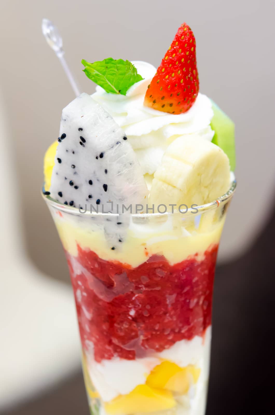 Ice cream and fruit in a cup.
