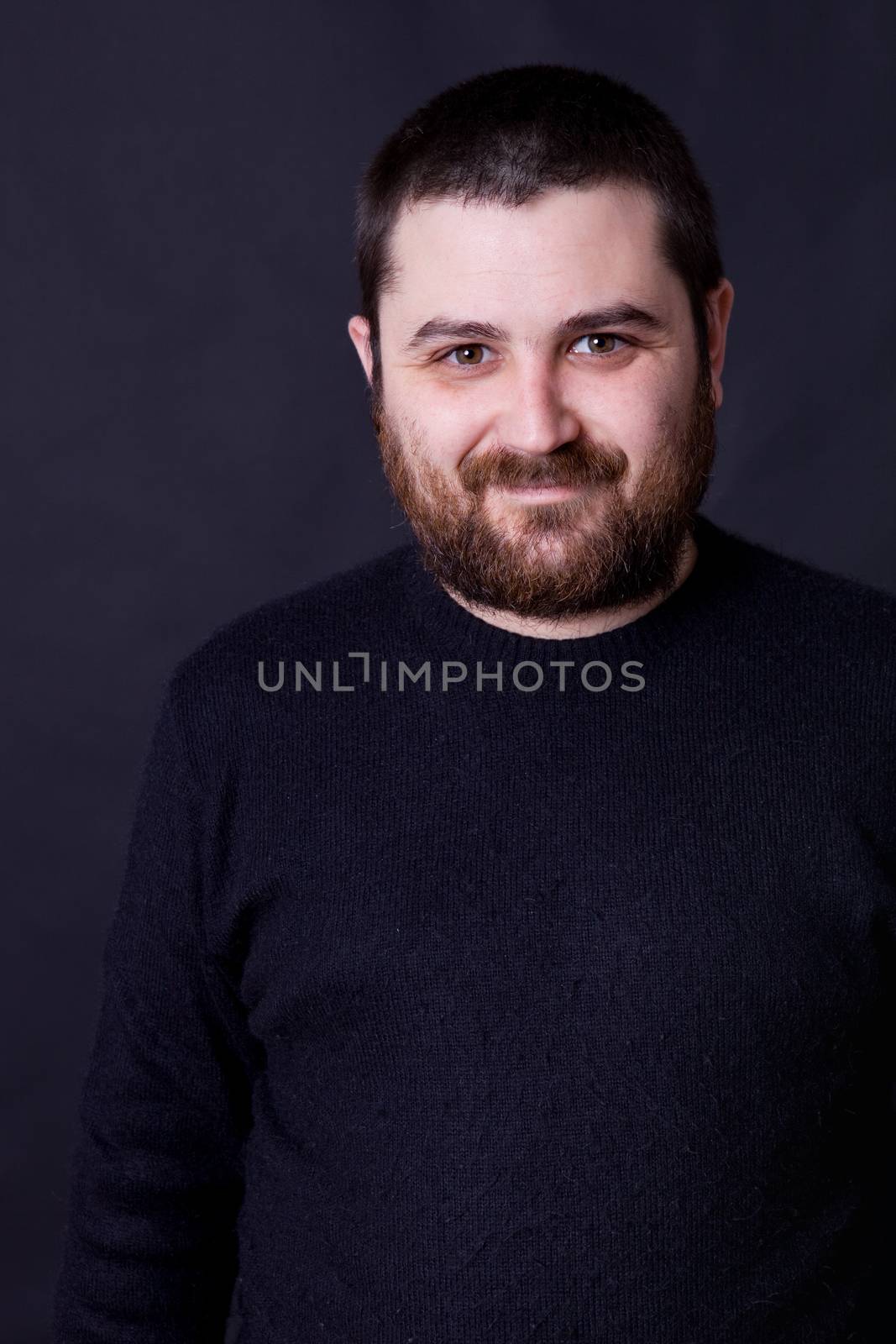 young casual man portrait on a black background