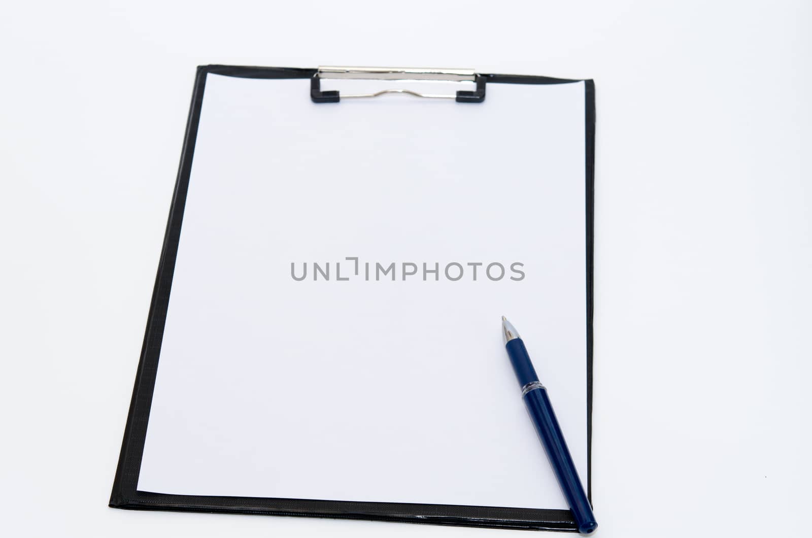 The clipboard and paper at the desk.