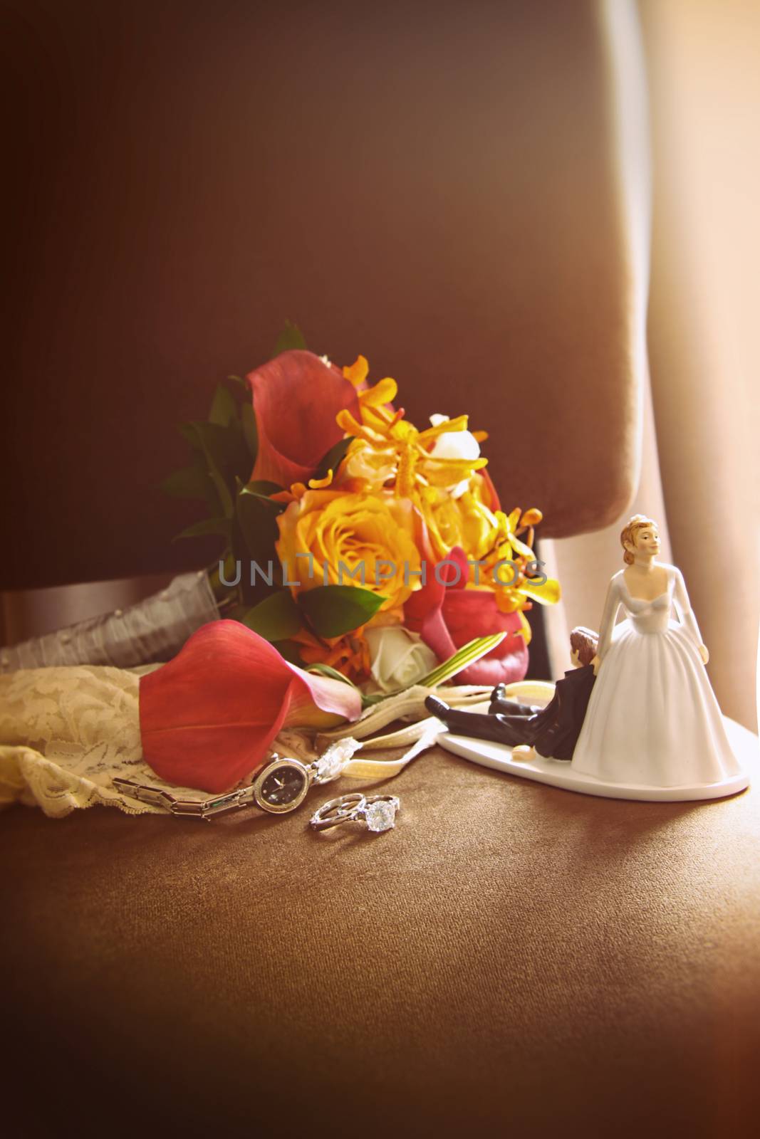 Cake figurines with bouquet on velvet chair