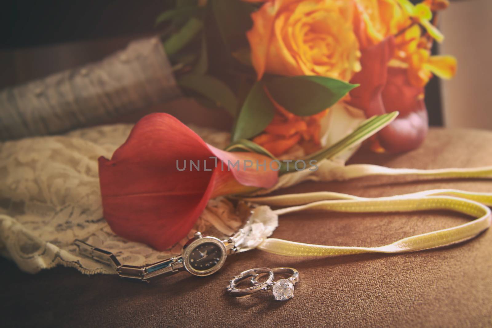 Wedding rings and accessories on velvet chair