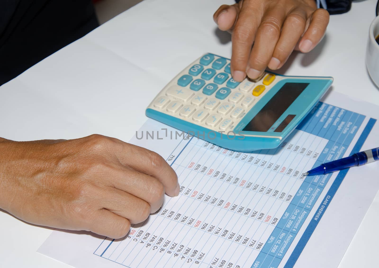 Accounting documents and a calculator placed at the table.