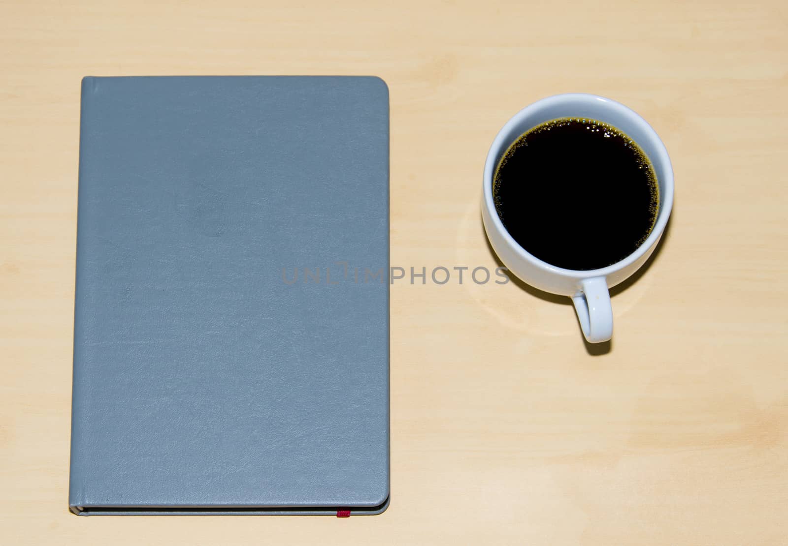 A coffee and books on the table.