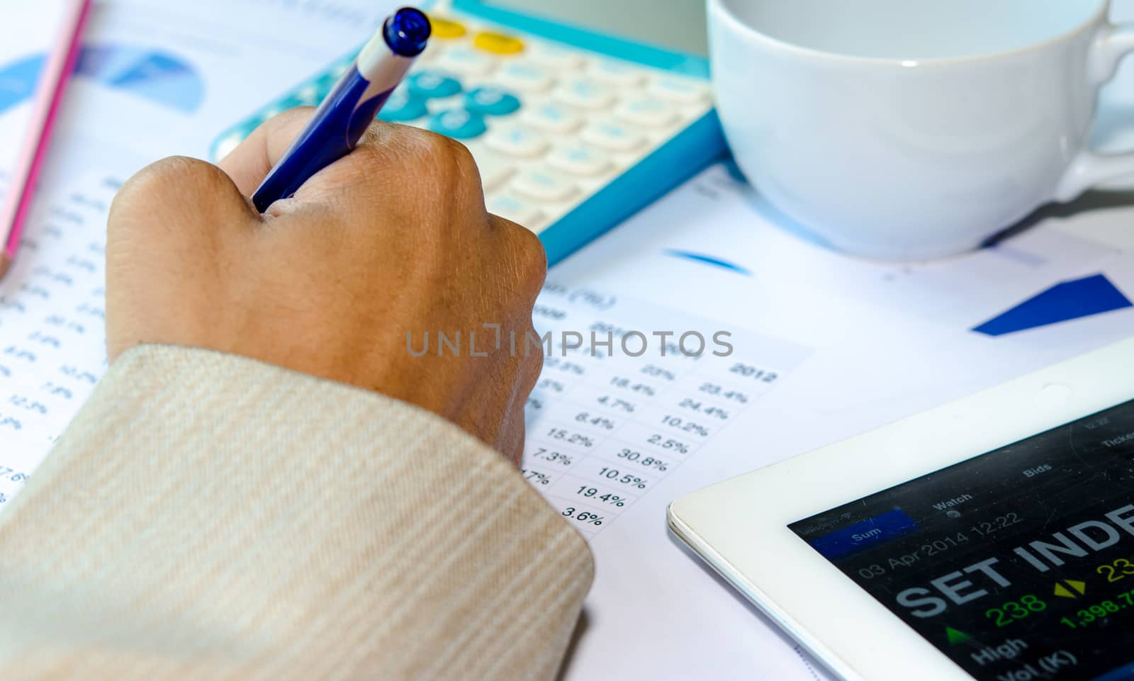 Hand writing with a pen, Financial report.