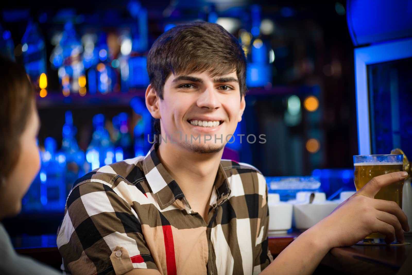 portrait of a young man at the bar, fun nightlife