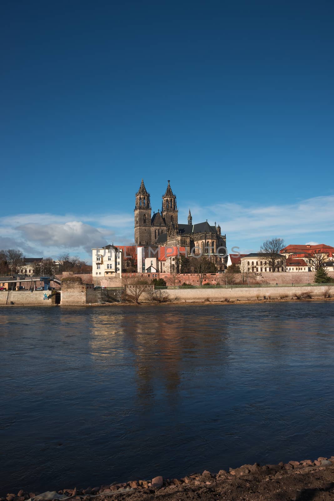 Magnificent Cathedral of Magdeburg at river Elbe with blue sky, Germany