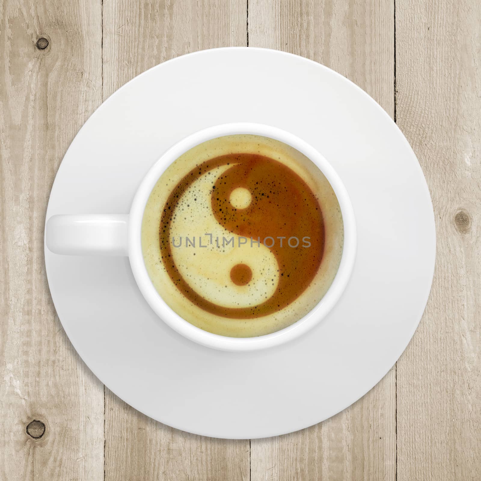 Cup of coffee standing on a wooden surface. Picture of the yin-yang in the coffee crema. top view