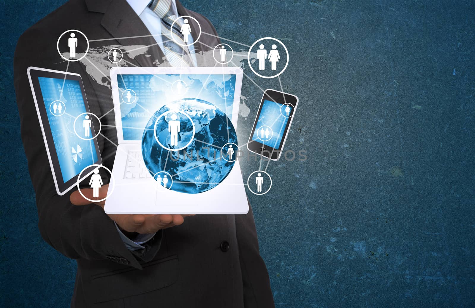 Businessman in a suit holding earth and electronics. Elements of this image are furnished by NASA