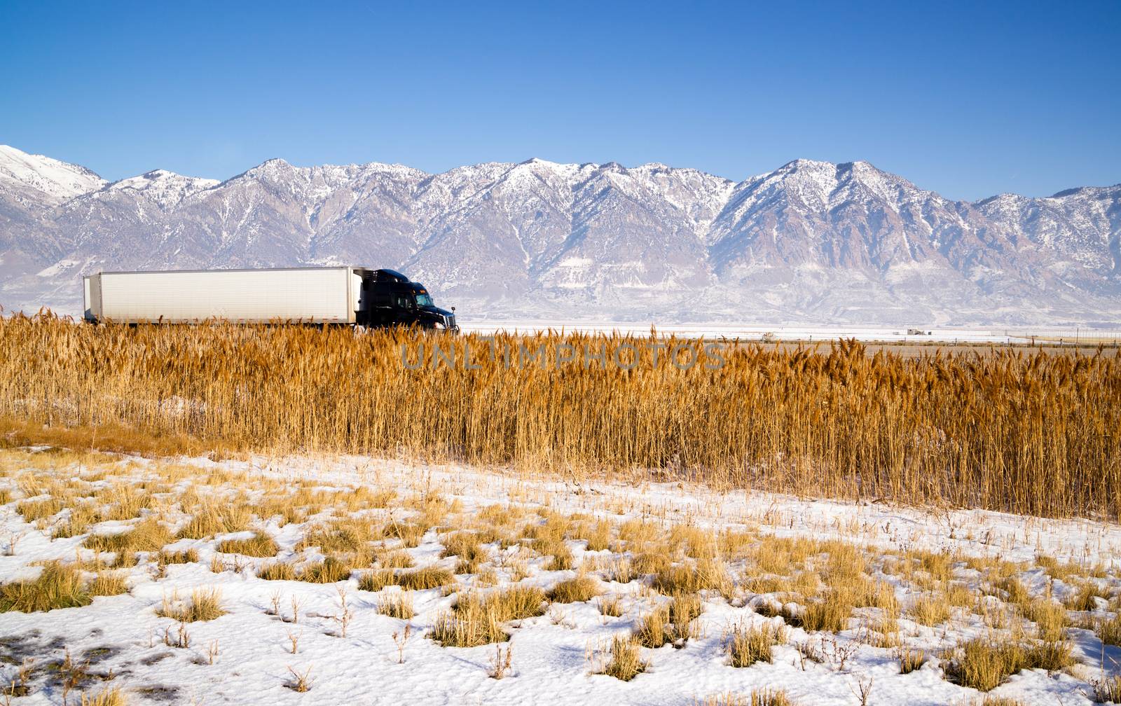 Semi Truck Speeding down Utah Highway Winter Wasatch Mountains by ChrisBoswell