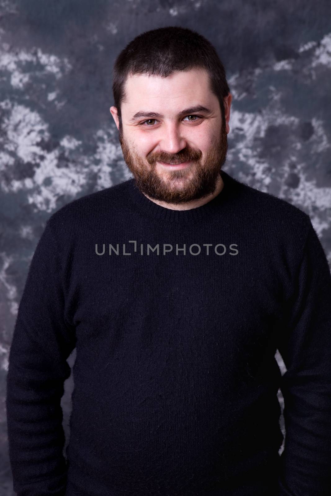 young casual man portrait on a dark background