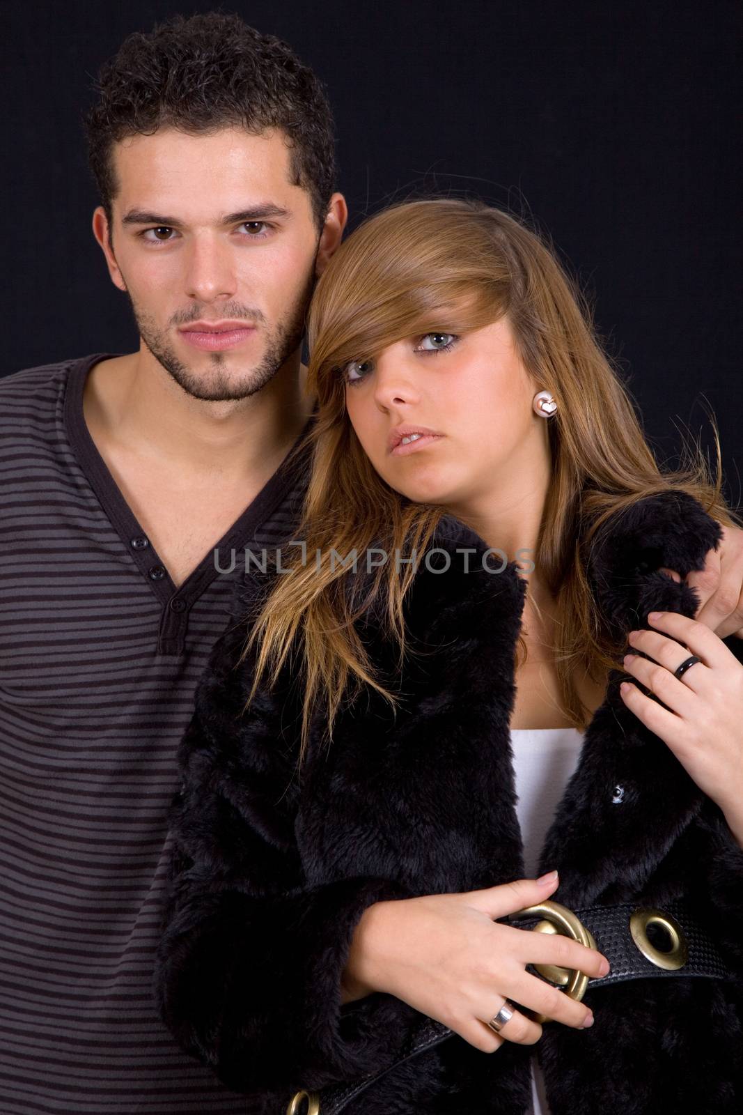 young couple together portrait on black background