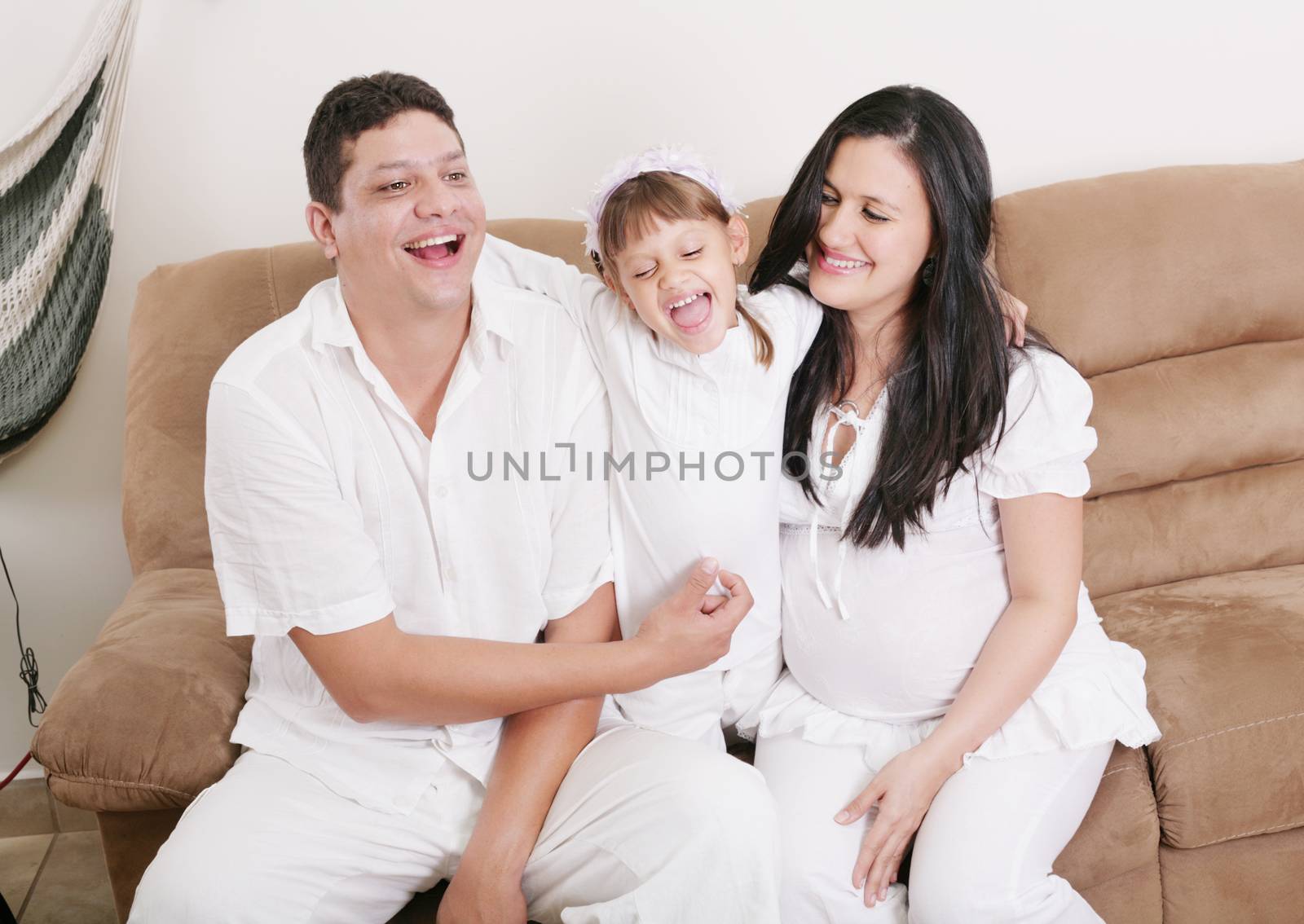 Happy American Family Playing with daughter in the living room by dacasdo