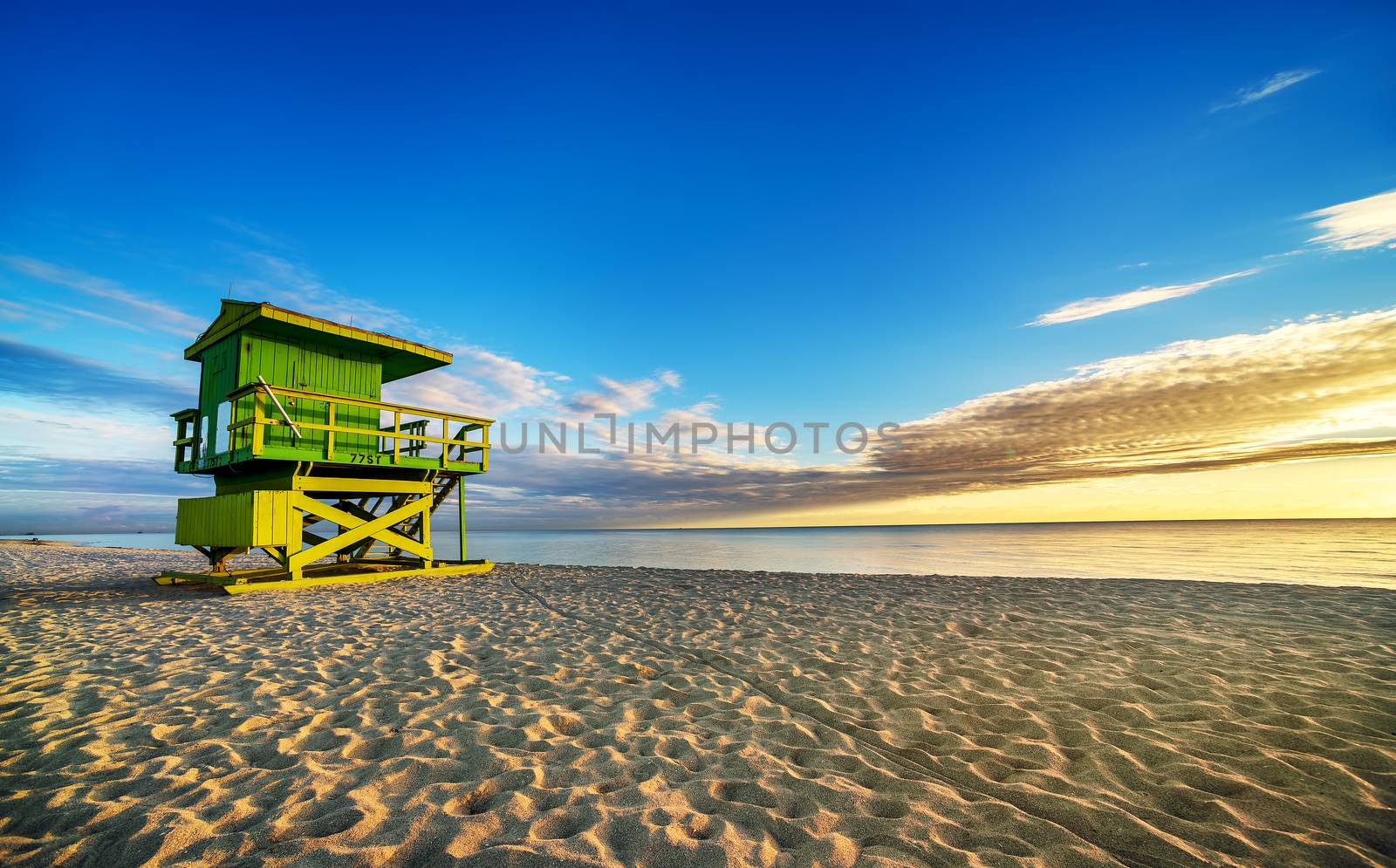 Miami South Beach sunrise with lifeguard tower and coastline with colorful cloud and blue sky. 