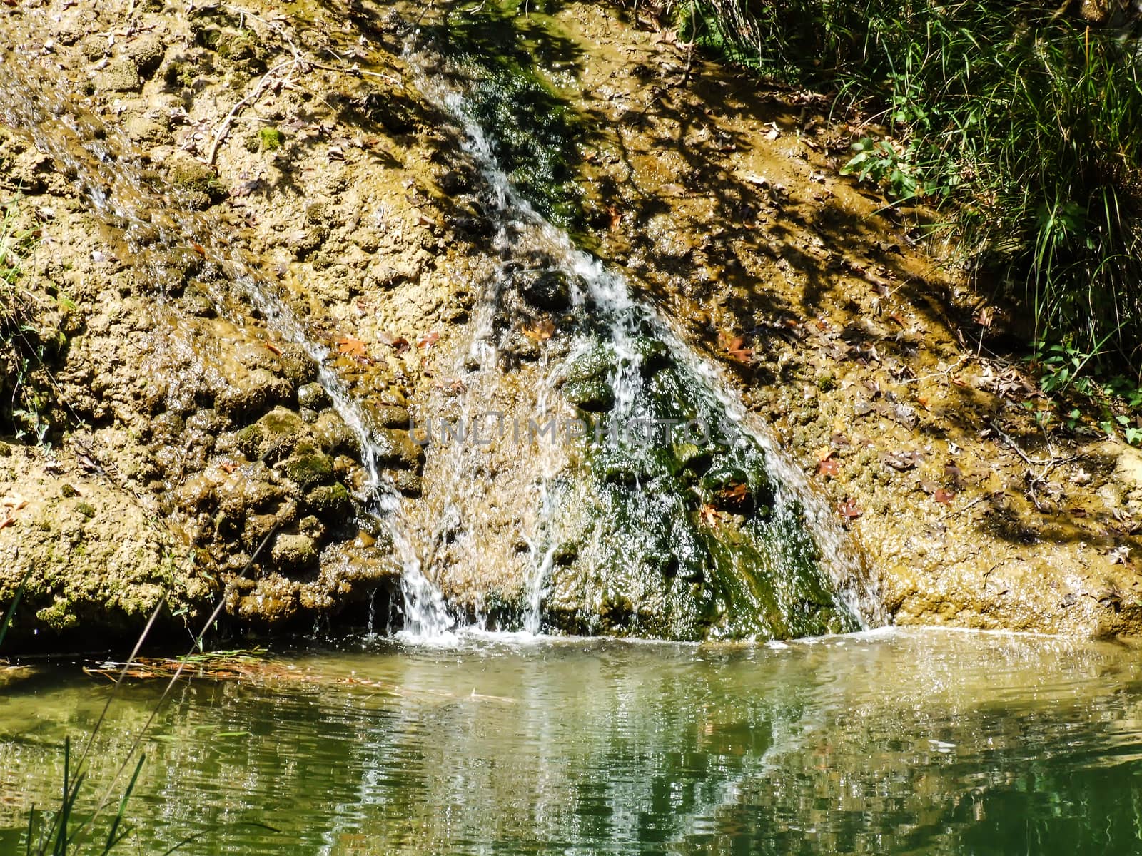 Small water fall with rocks in the mountains