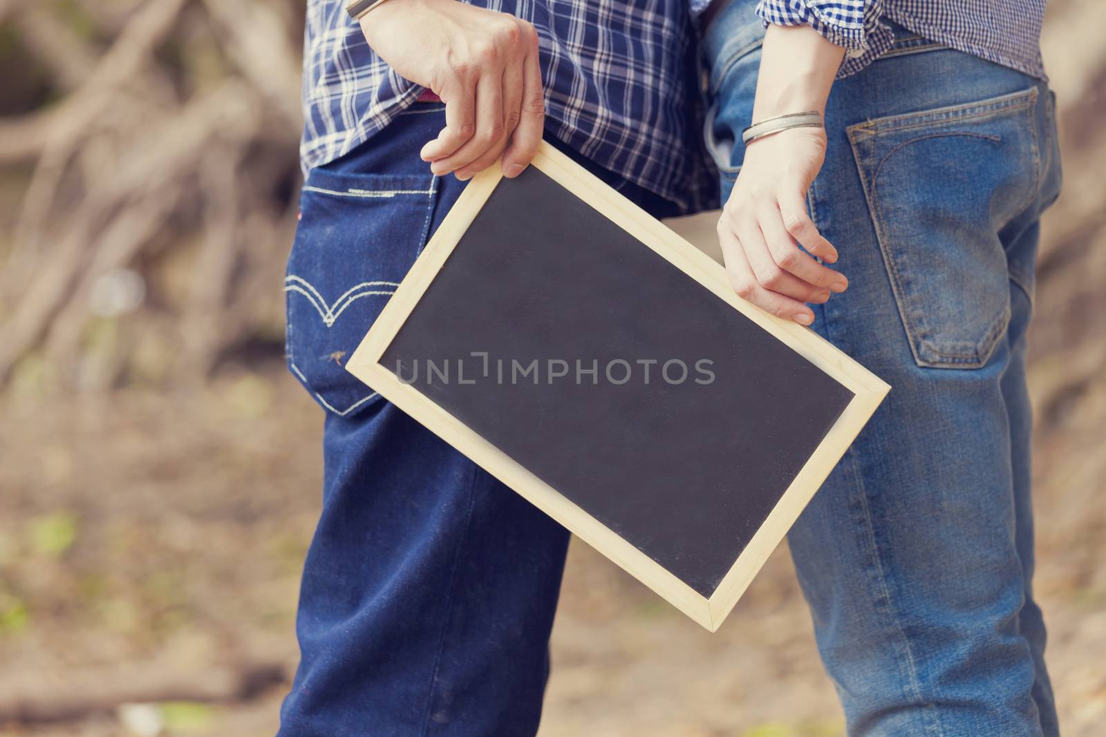 Wedding couple holding black board