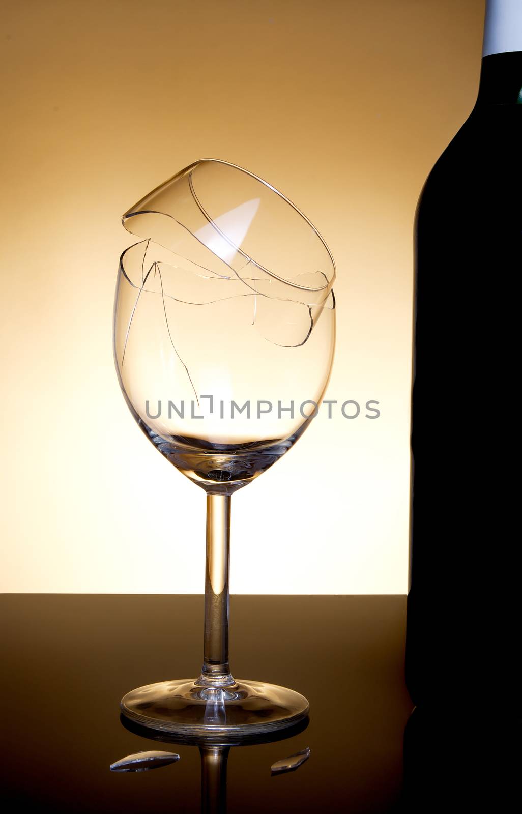 Vine bottle and broken glass on orange background by anderm