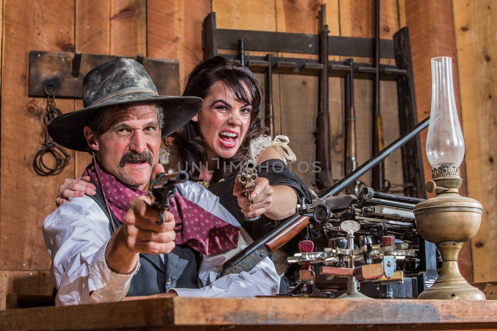 A Shouting Cowboy and Saloon Girl Point Their Weapons at You