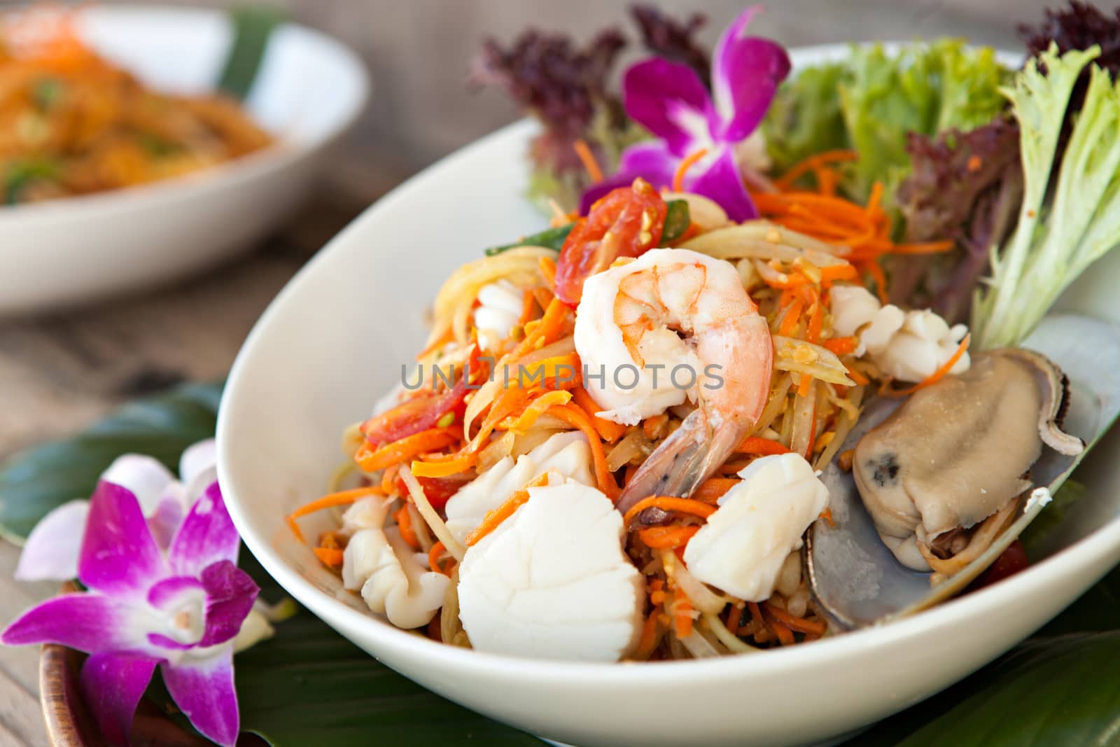 Traditional dish of freshly prepared Thai food.  Thai seafood and som tum green papaya salad.