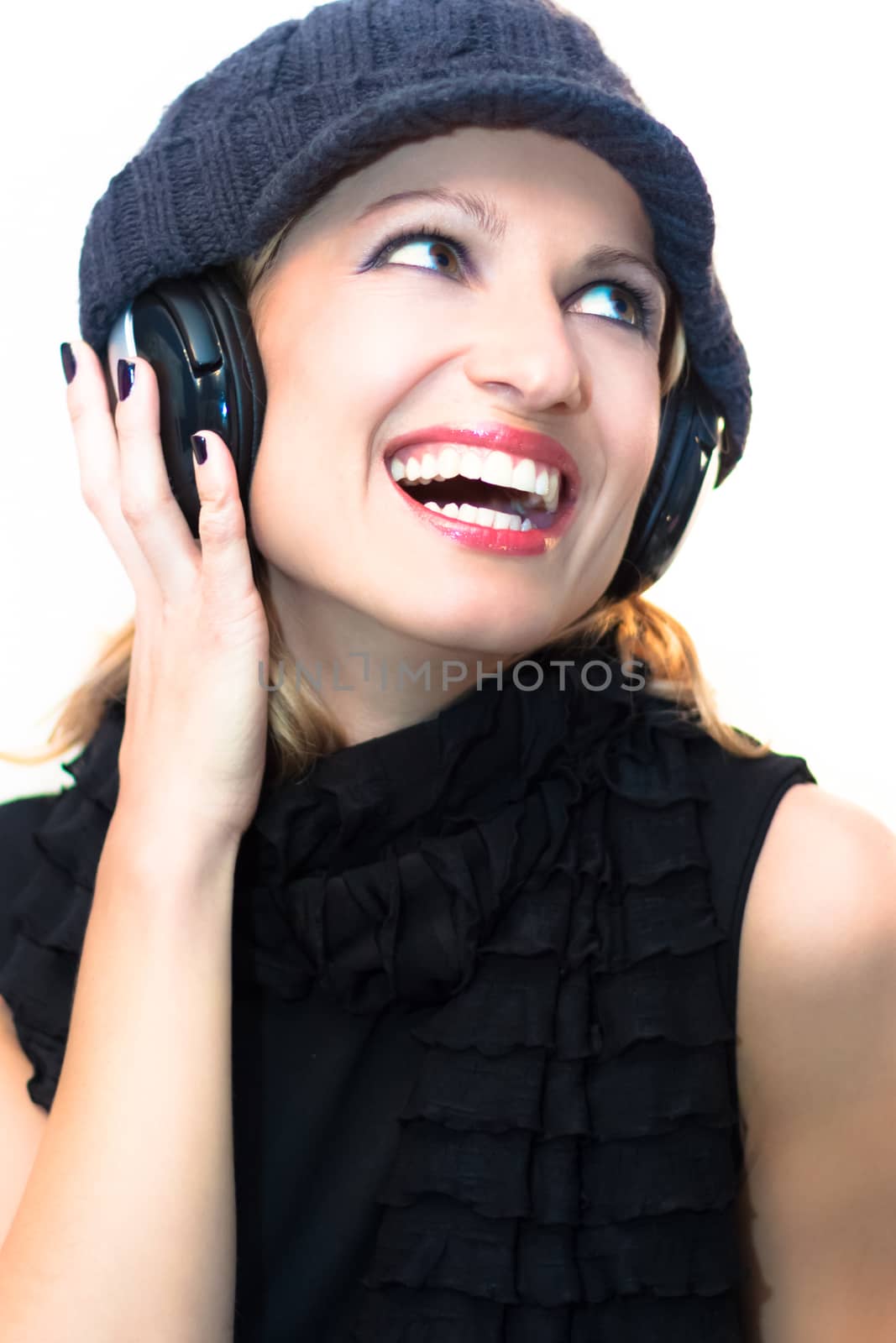 Blonde caucasian girl listening to the music with a pair of headphones