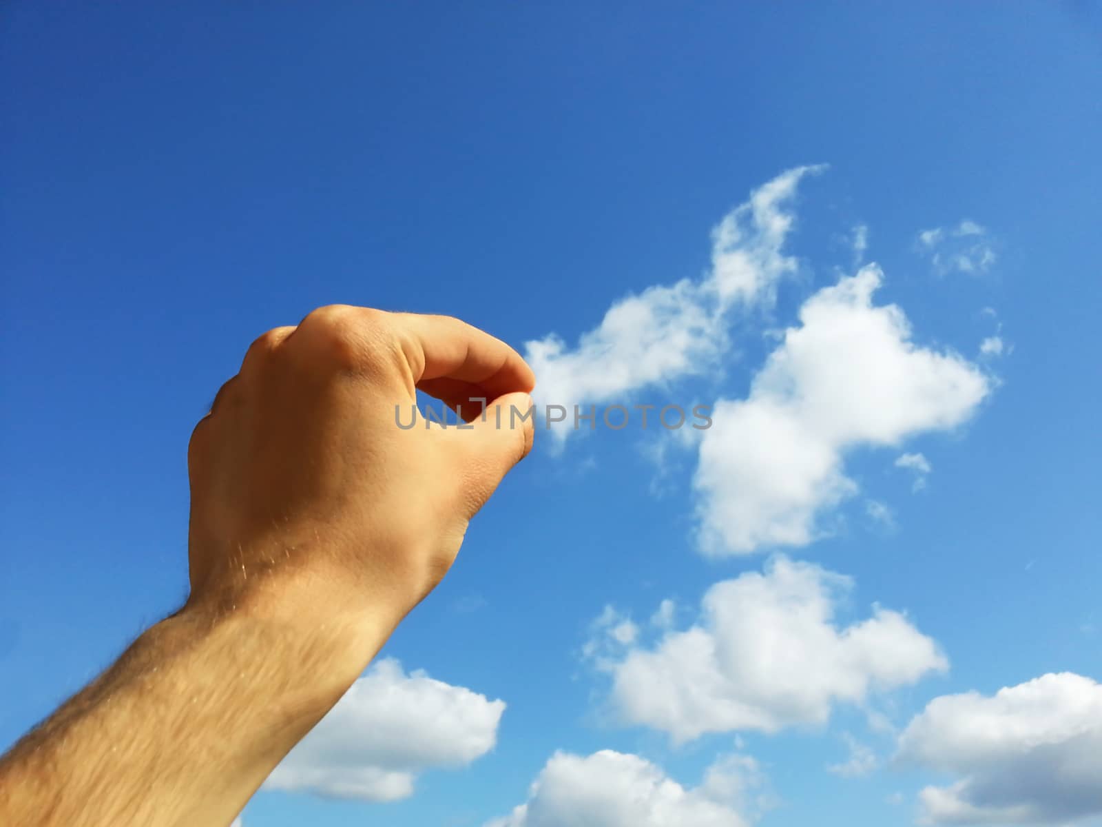 Abstract concept of hand pulling a cloud with copyspace.