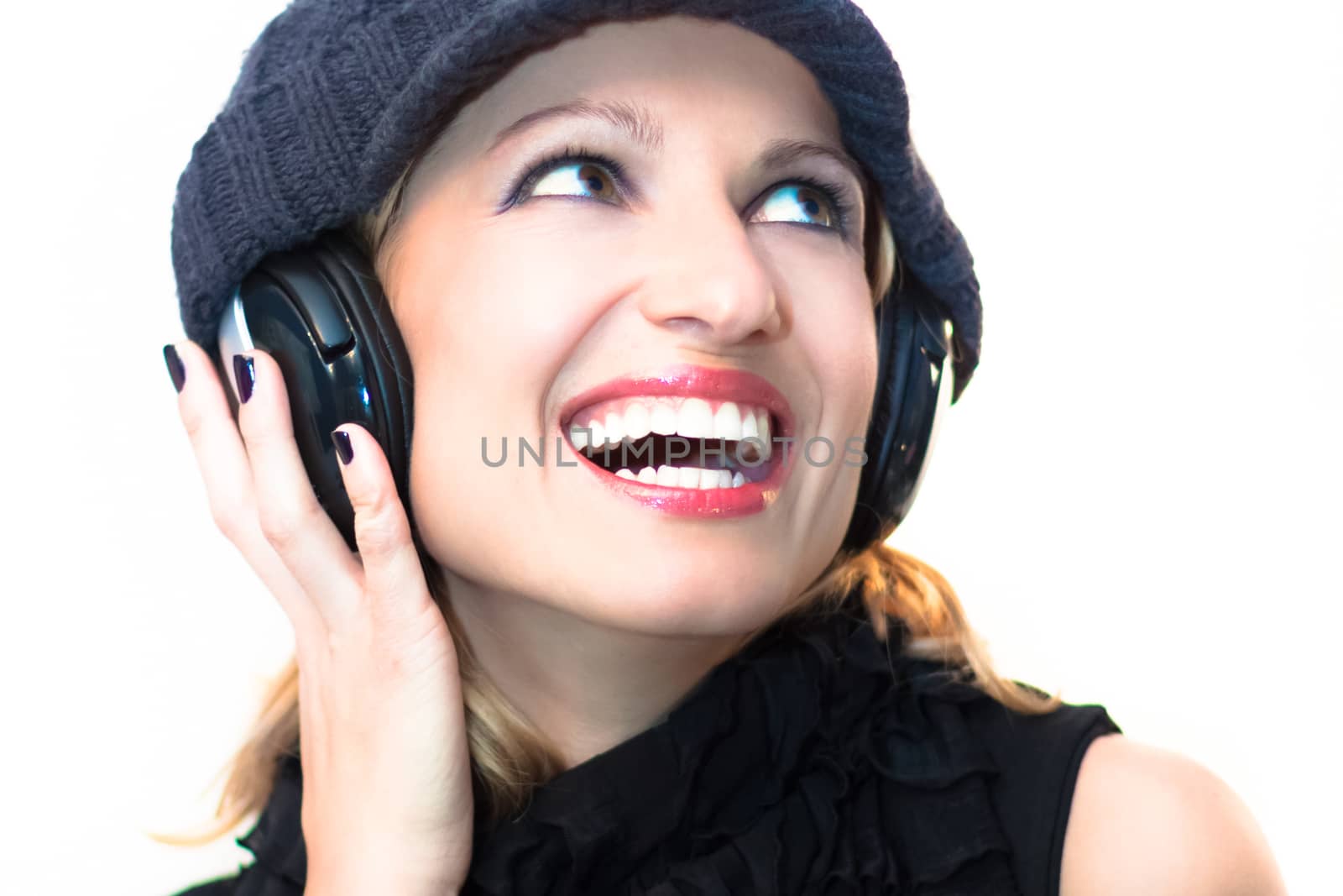 Blonde caucasian girl listening to the music with a pair of headphones