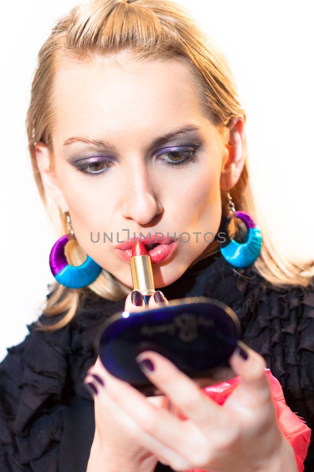 Young beautiful woman applying fashionable colorful party make-up.