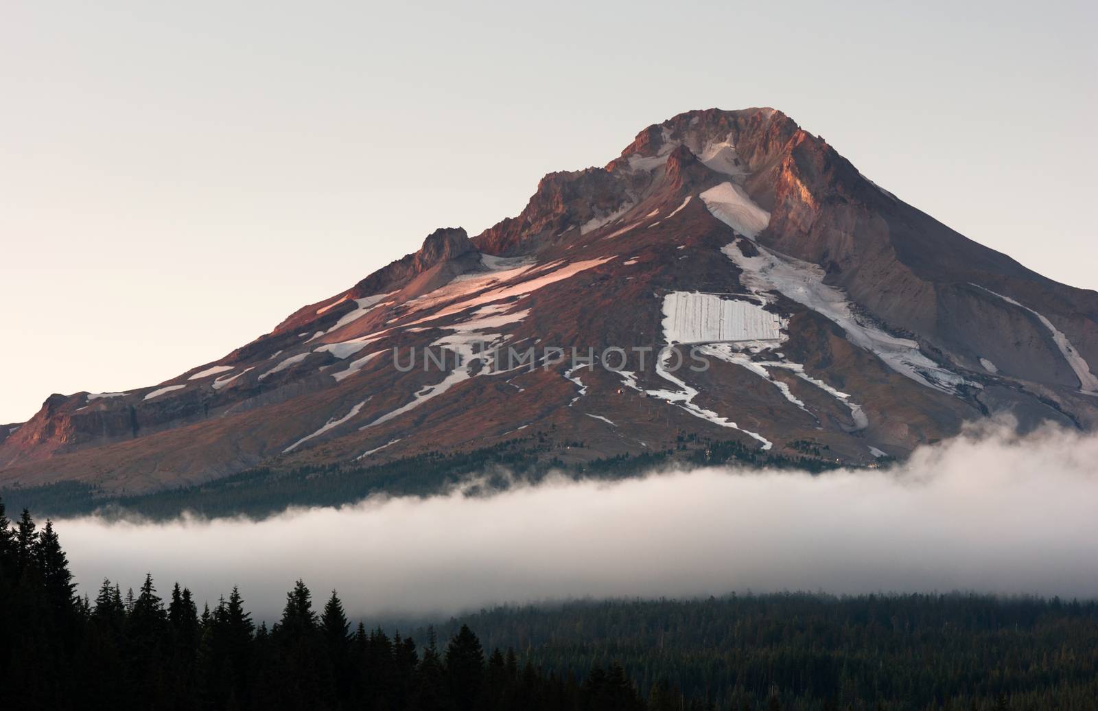 An almost square piece of snow sits on the side of Mount Hood man made for people to ski on